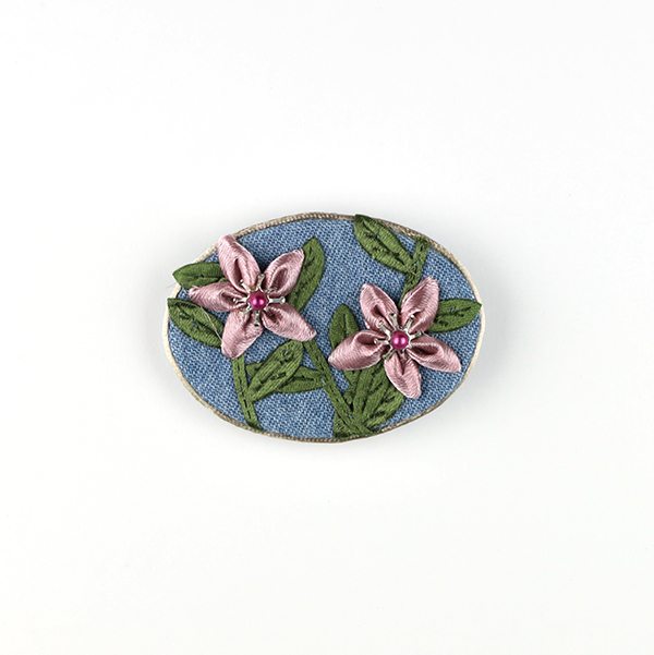 B646 リボンフラワー(だ円)<br>制作者:CHAi<br>サイズ:4.5cm×6.5cm<br>素材:布、リボン、ビーズ、座金、サテンコード、ブローチピン<br><br>リボンの花が咲きました。