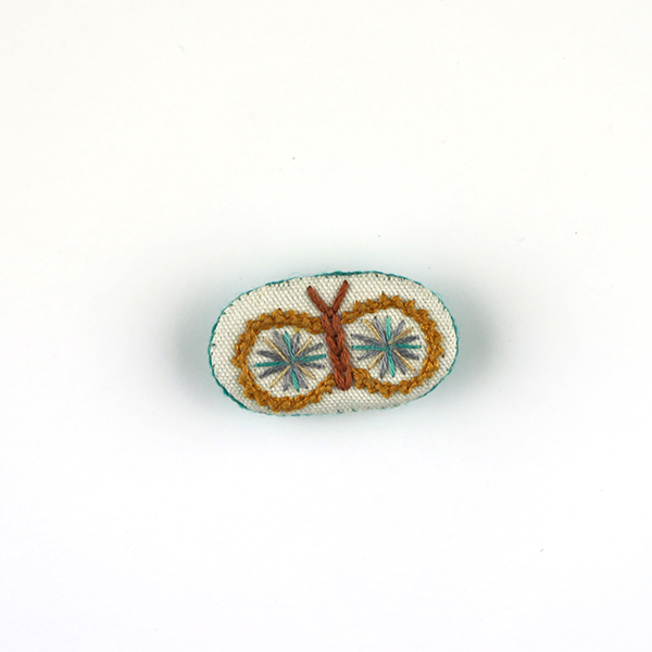 B731 ちょうちょブローチ<br>制作者:Tono Tono<br>サイズ:2.5cm×4.5cm<br>素材:フェルト、刺繡糸、布、綿、ブローチピン<br><br>水戸芸→森英恵氏→ちょうちょ